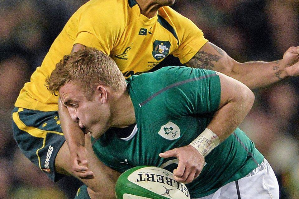 Ian Madigan, Ireland, is tackled by Will Genia, Australia