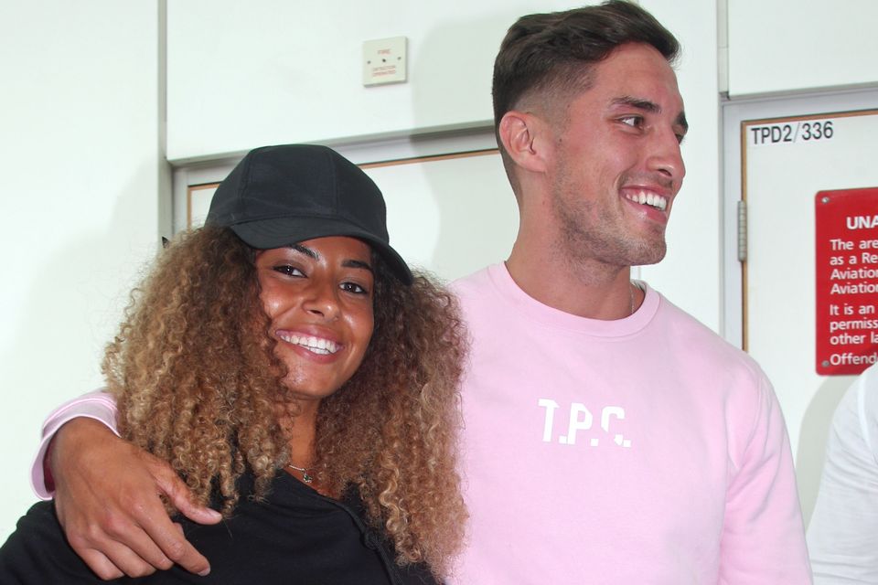 Love Island winners Amber Gill and Greg O'Shea and contestants Molly Mae  Hague and Tommy Fury (rear left to right) greet fans as they arrive at  Stansted Airport in Essex following the