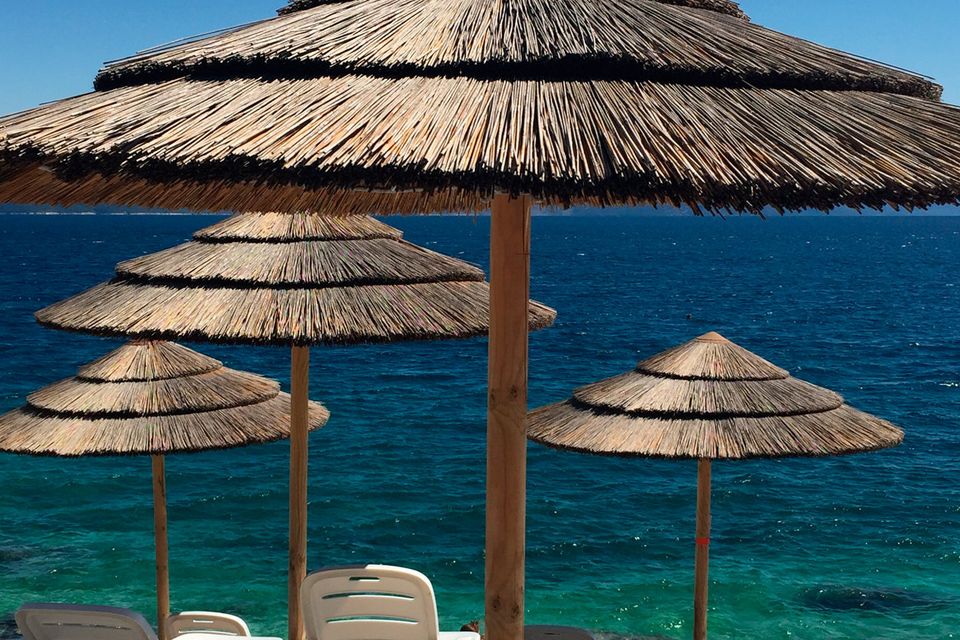 You can rent a lounger and straw umbrella on Lanterna beach