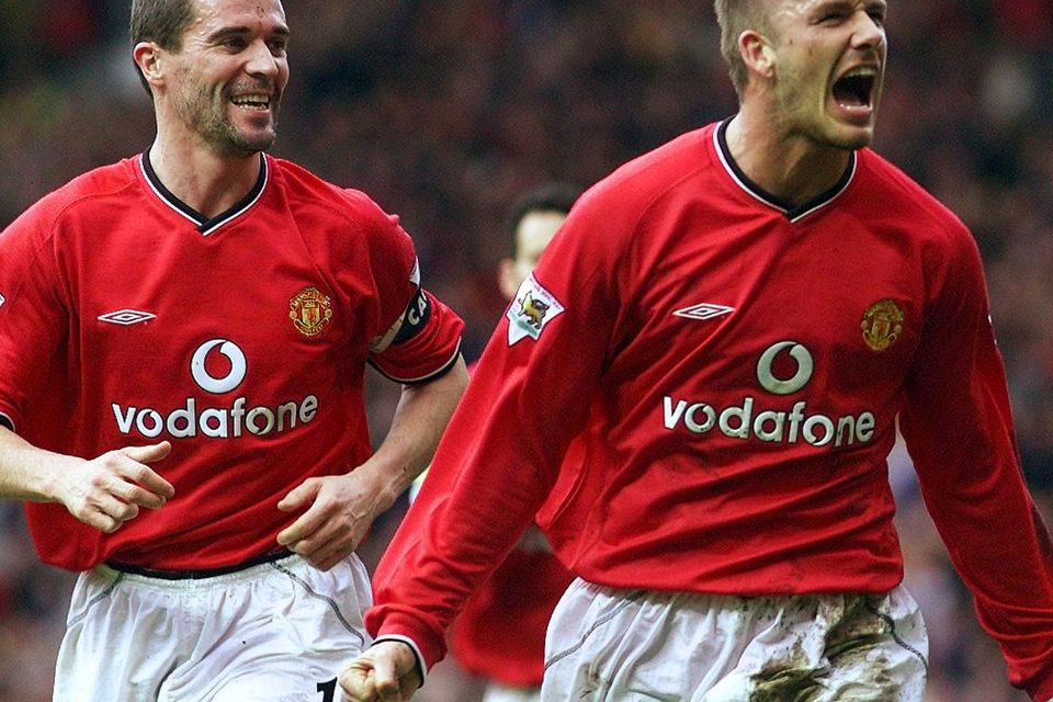 Manchester United's David Beckham (R) celebrates scoring against Sunderland with captain Roy Keane (L) during their English premier league match at Old Trafford, Manchester, February 2, 2002.  REUTERS/Ian Hodgson