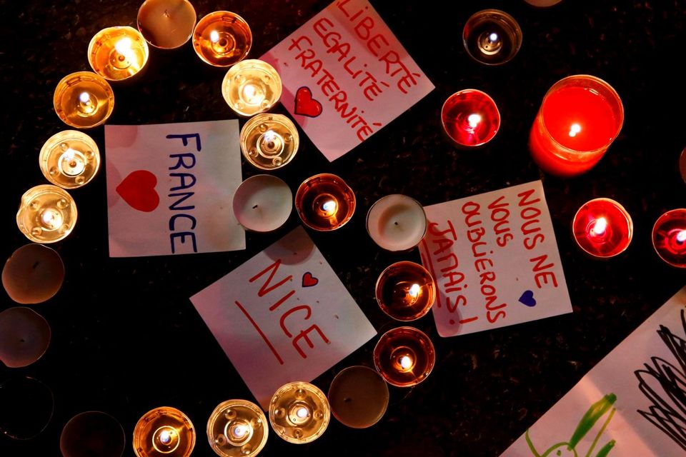 Burning candles, messages and a drawing pay tribute to victims of the truck attack along the Promenade des Anglais on Bastille Day that killed scores and injured as many in Nice. Photo: Pascal Rossignol/Reuters