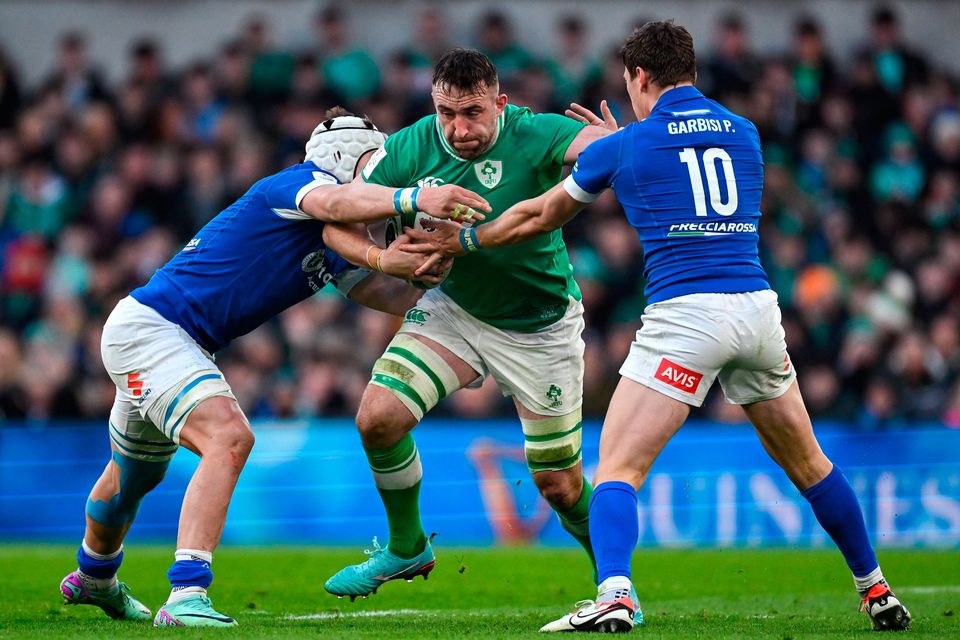 Ireland No 8 Jack Conan is tackled by Manuel Zuliani and Paolo Garbisi of Italy