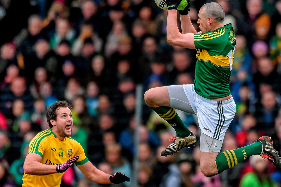 Kerry captain Kieran Donaghy rises highest to claim possession ahead of Donegal’s Michael Murphy in Tralee.