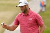 thumbnail: Jon Rahm waves to the gallery as he walks to the 13th green during