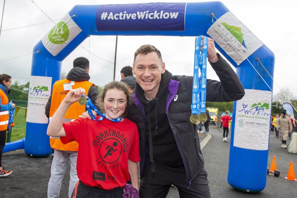 Matilda Ayton from Donard NS with Olympian David Gillick at the Marathon Kids Run in Ballymore Eustace GAA. Photo: Michael Kelly