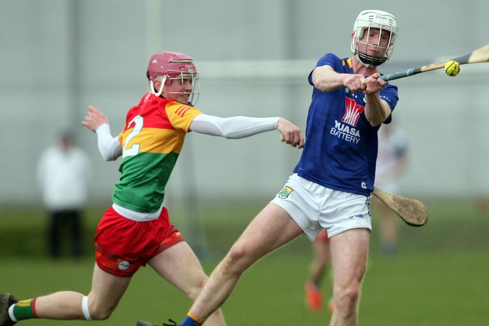 Wicklow's Lorcan Byrne gets his shot away as Carlow's Martin Carroll tries to hook.