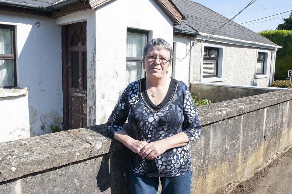 Concerned neighbour Veronica Houlihane who resides in the house on the right in the picture. Mrs Hourihane's house is adjoined to the derelict house in Old Garden City. Pic: Jim Campbell