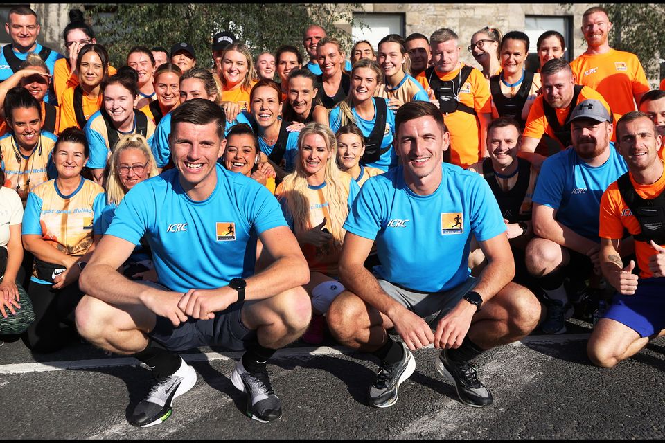 Dwayne Edgar and Karl Taaffe with members of Inner City Running Club in 2021. Pic: Steve Humphreys