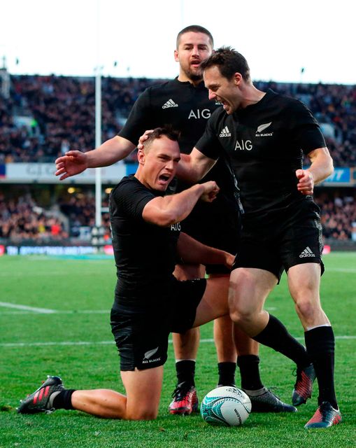 New Zealand's Israel Dagg (front) celebrates his try with teammates Dane Coles and Beauden Barrett (R) during the third rugby Bledisloe Cup Test between the New Zealand All Blacks and Australia