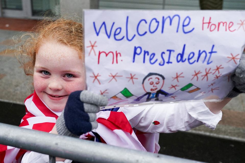 A girl holds a placard as U.S. President Joe Biden visits Dundalk, Ireland, April 12, 2023. REUTERS/Kevin Lamarque