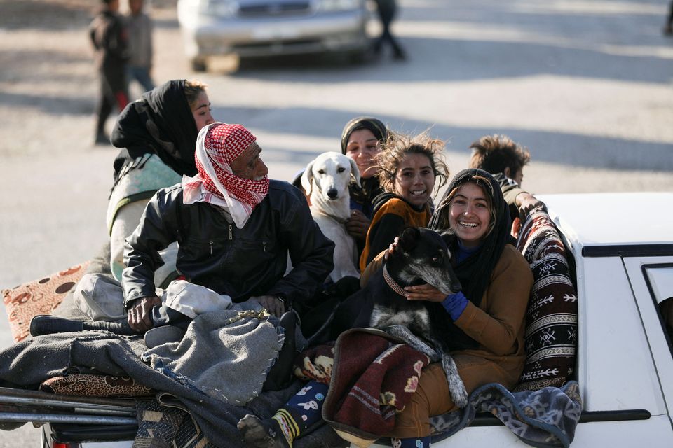 Displaced people who fled from Aleppo travel in Tabqa, Syria. Photo: Reuters
