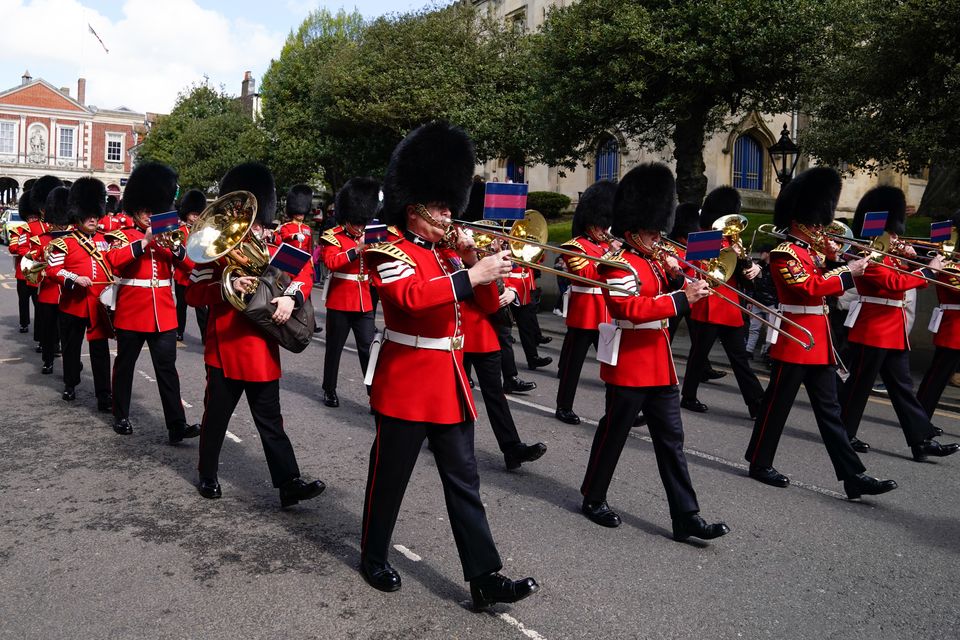 The band of the Welsh Guards march down the High Street towards Victoria barracks in Windsor after a changing of the guards ceremony at Windsor Castle (Andrew Matthews/PA)