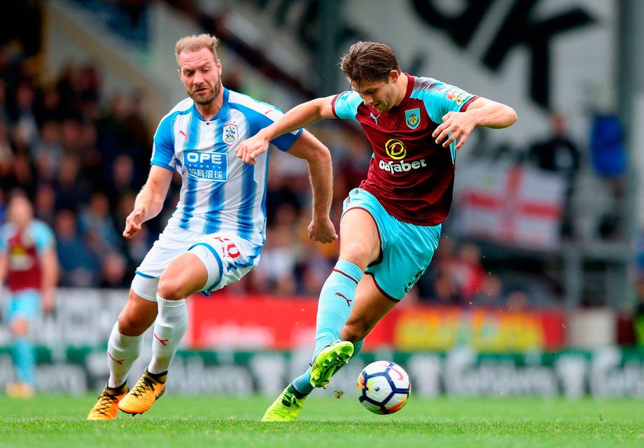 James Tarkowski of Burnley controls the ball under the pressure of Laurent Depoitre. Photo: Getty