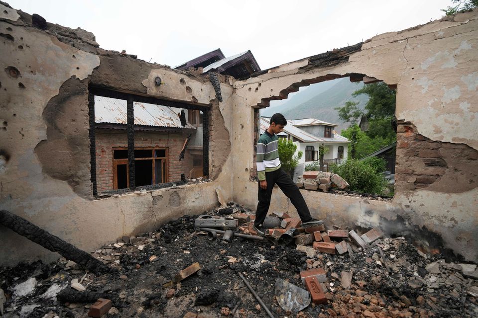 A Kashmiri village boy walks inside a house damaged by Pakistani artillery shelling, at Salamabad village in Uri, north of Srinagar, Indian controlled Kashmir yesterday. Photo: AP