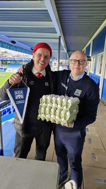 A Kristiansund BK official holds eggs given out by the Bryne FK soccer club to the best player in a match, at Nordmore Stadium in Kristiansund, Norway
