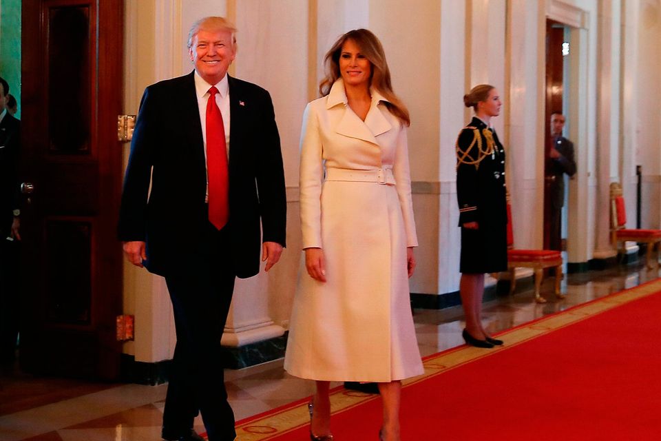 U.S. President Donald Trump and first lady Melania Trump walk into the East Room to attend an event celebrating Women's History Month, at the White House March 29, 2017 in Washington, DC.   (Photo by Mark Wilson/Getty Images)