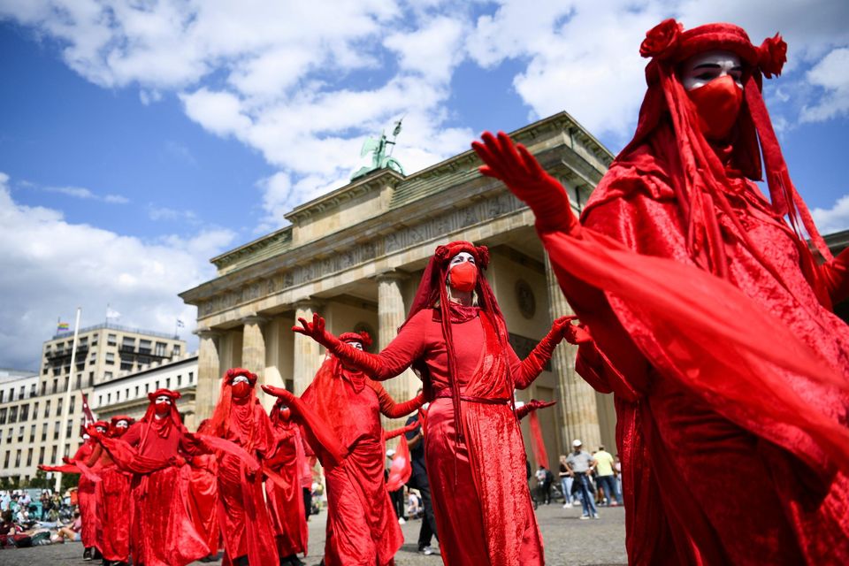 Extinction Rebellion activists walk past the Brandenburg Gate as they take part in a protest to demand actions against climate change, in Berlin, Germany. Picture: Reuters/Annegret Hilse