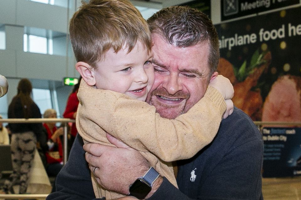 Mike Hoare from Dubai is greeted by his son Donal Hoare (6) at Dublin Airport today. Photo: Gareth Chaney/ Collins Photos