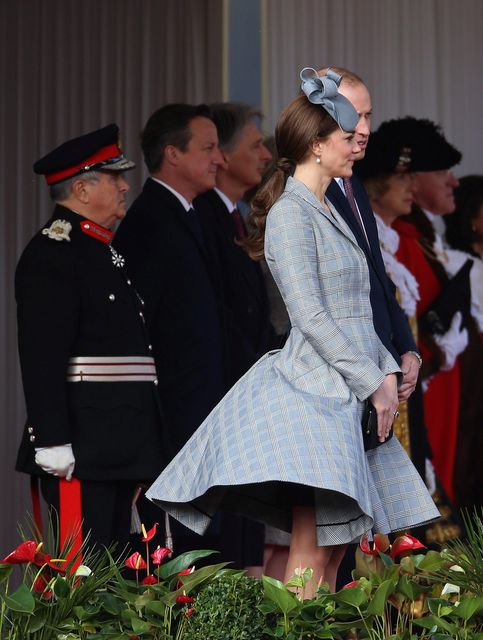 Catherine, Duchess of Cambridge's skirt catches the wind as she is seen ready to welcome the President of Singapore Tony Tan Keng Yam (not seen) at the Royal Garden Hotel