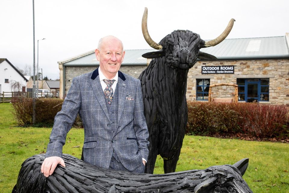Hugh Nolan with a teak bull that is also up for auction