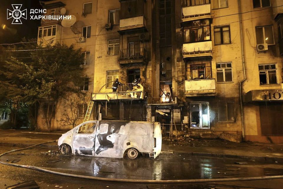 Emergency services personnel work to extinguish a fire following a Russian attack in Kharkiv (Ukrainian Emergency Service via AP)
