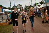 thumbnail: Revellers walk along a pathway past stalls at the Glastonbury Festival of Music and Performing Arts on Worthy Farm near the village of Pilton in Somerset, South West England, on June 26, 2019. (Photo by Oli SCARFF / AFP)OLI SCARFF/AFP/Getty Images