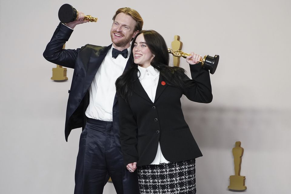 Finneas O’Connell and Billie Eilish pose in the press room with the award for best original song for What Was I Made For?(Jordan Strauss/Invision/AP)