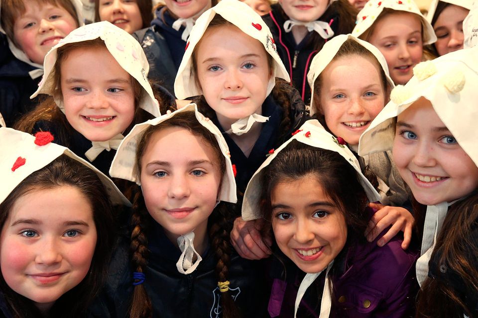 Pupils from Rathgar junior school wear bonnets on their heads for a photo project to remember thousands of women incarcerated at Grangegorman in the 1840s and 50s prior to their transportation to Van Diemen’s Land. Photo: Damien Eagers