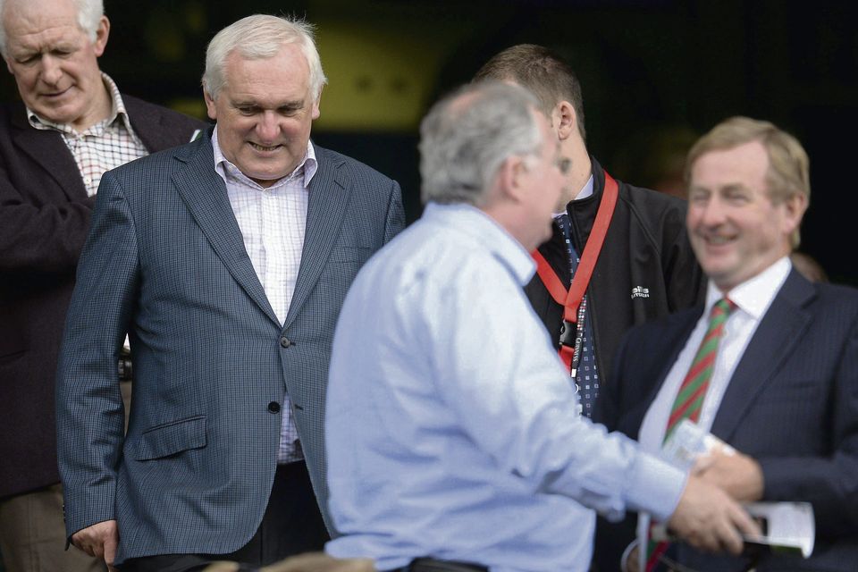 Bertie Ahern and his brother Maurice find seats as  Taoiseach Enda Kenny, right, speaks with Pat Rabbitte