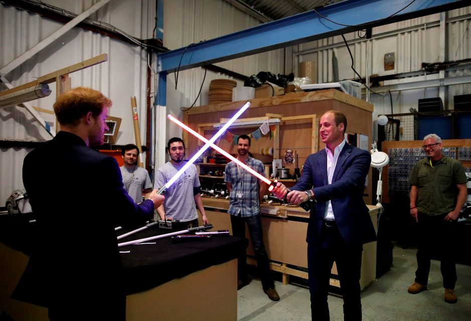 Prince Harry (L) and Prince William, Duke of Cambridge try out light sabres during a tour of the Star Wars sets at Pinewood studios on April 19, 2016  in Iver Heath, England.  (Photo by Adrian Dennis-WPA Pool/Getty IMages)