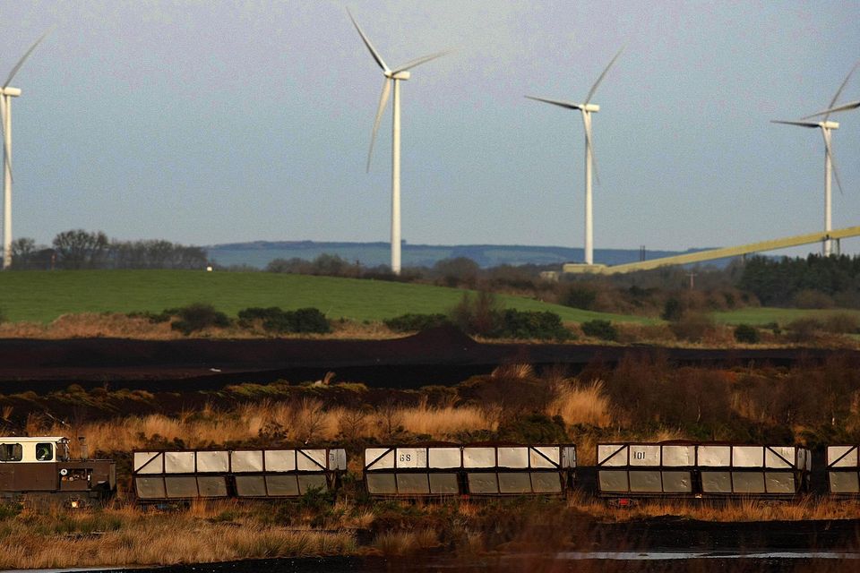 A peat bog and a wind farm (Julien Behal/PA)