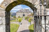 thumbnail: The front of the house as viewed through the archway
