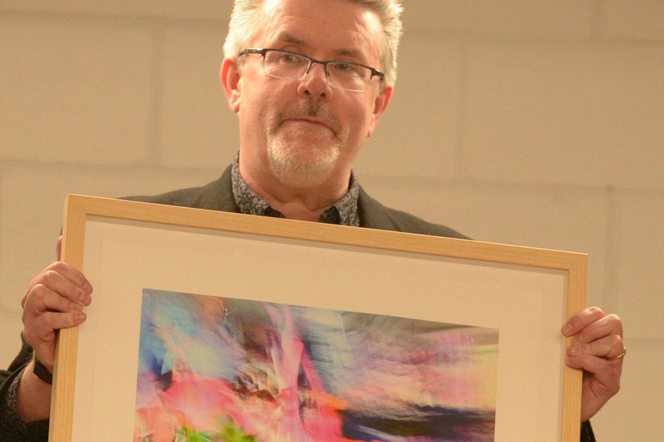 Millstreet Community School co-ordinator John Magee with a painting by Leanne McDonagh and on display in the Millstreet school courtesy of the Glucksman’s Theatre.