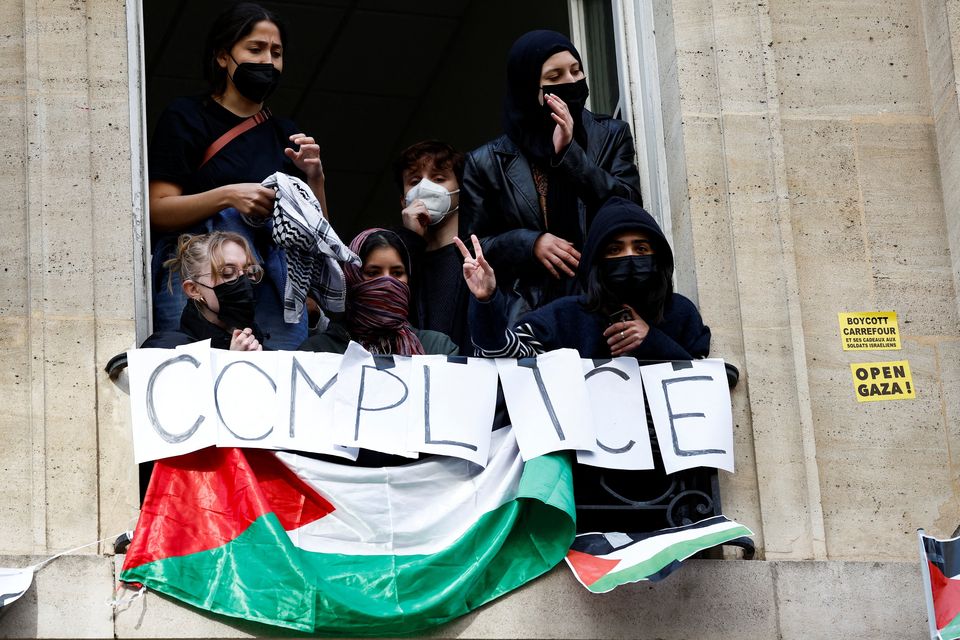Masked youths take part in the occupation of a building of the Sciences Po University in Paris: Photo: Reuters