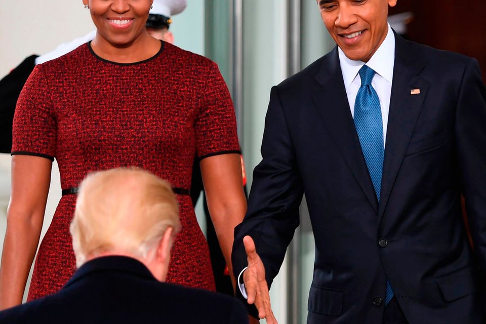 President-elect Donald Trump(C)is greeted by President Barack Obama and First Lady Michelle Obama(L) as he arrives at the White House
