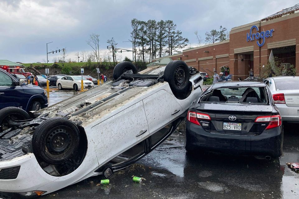 A car is upturned after a severe storm swept through Little Rock, Arkansas (Andrew DeMillo/AP)