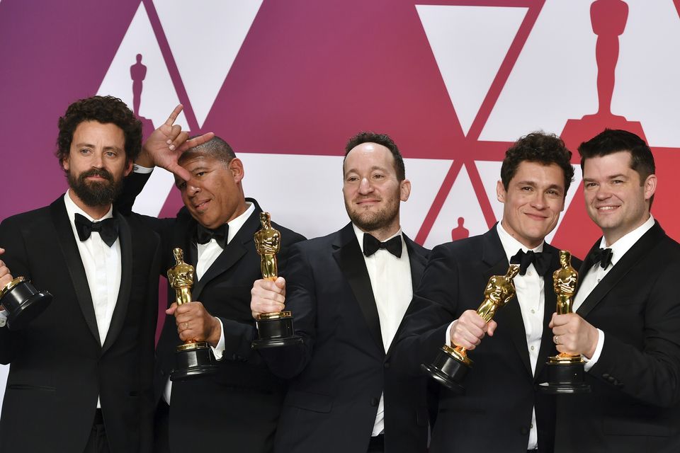 Bob Persichetti, from left, Peter Ramsey, Rodney Rothman, Phil Lord and Christopher Miller pose with the Oscar for best animated feature film for Spider-Man: Into the Spider-Verse (Jordan Strauss/Invision/AP)