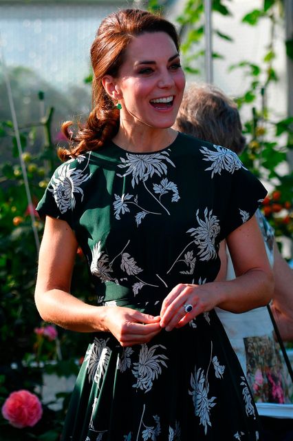 Britain's Catherine, Duchess of Cambridge, reacts after trying a tomato at the 'BBC Radio 2: Chris Evans Taste Garden' during her visit to the Chelsea Flower Show in London on May 22, 2017