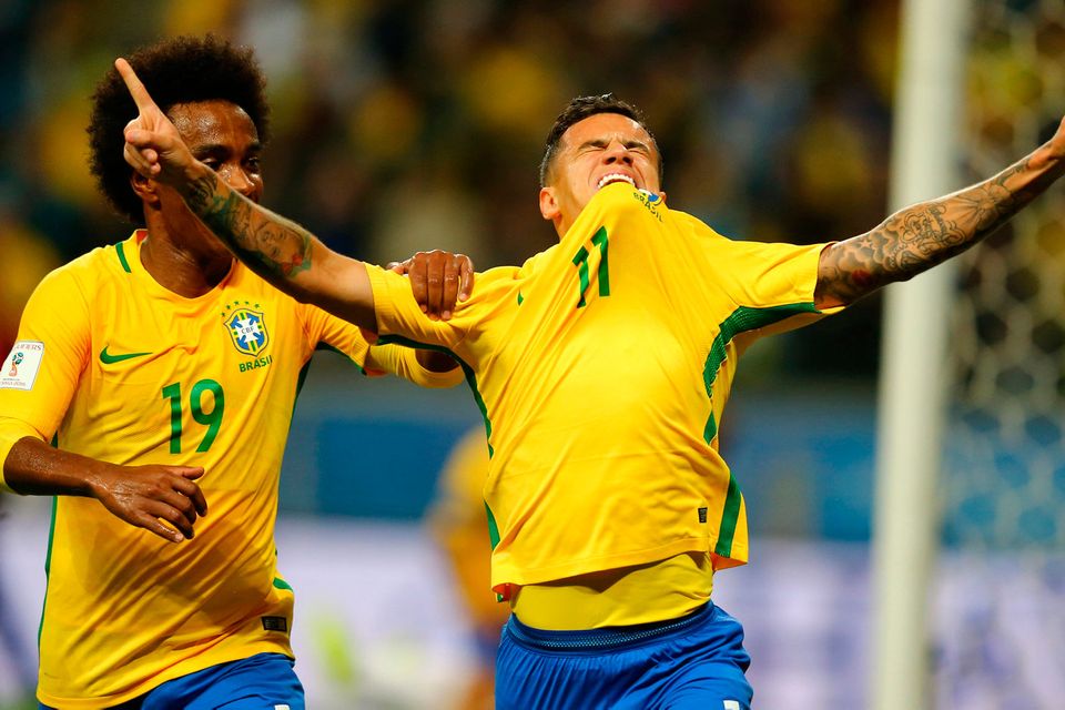 Philippe Coutinho (11) of Brazil celebrates his goal against Ecuador with teammate Willian