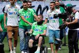 thumbnail: Chapecoense players Neto, left, goalkeeper Follmann, on the wheelchair, and Alan Ruschel, right, the three players that survived the air crash, arrive for an Sudamericana trophy award ceremony prior to a friendly match against Palmeiras, in Chapeco, Brazil
