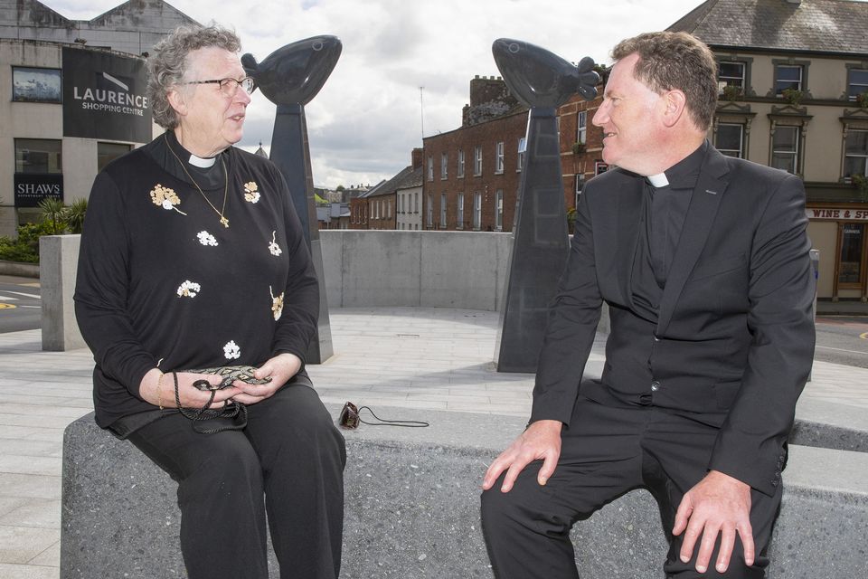 Rev. Joyce Moore of St. Peter’s Church of Ireland with Canon Eugene Sweeney of St. Peter’s Roman Catholic church at the art installation.  The piece symbolises birds sitting on the spires of each church.
