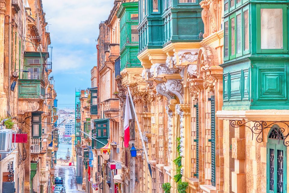 Many of the apartments that line Valletta's steep streets have traditional enclosed balconies. Photo: Getty