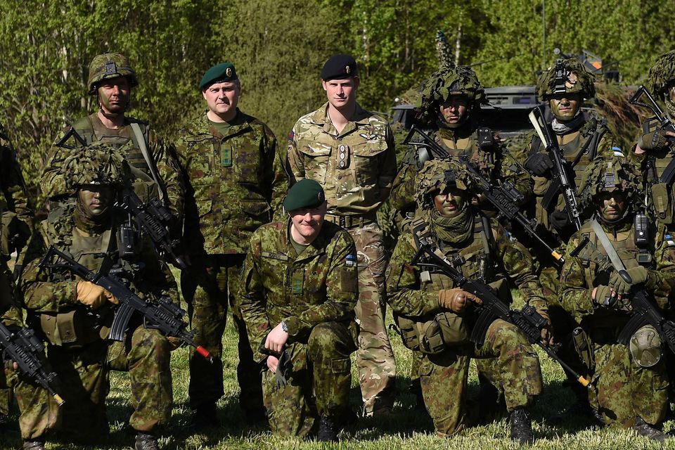Prince Harry (centre) poses for a photo with members of the Estonian army a military exercise in Sangaste
