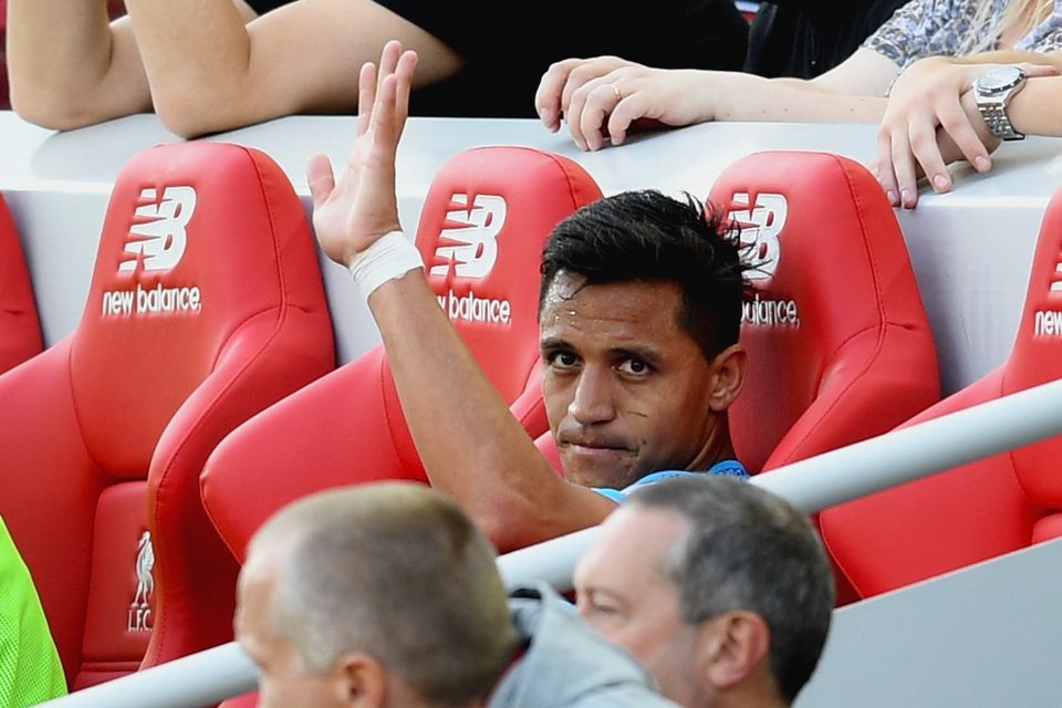 Alexis Sanchez of Arsenal waves after being subbed during the Premier League match between Liverpool and Arsenal at Anfield on August 27, 2017 in Liverpool, England.  (Photo by Michael Regan/Getty Images)