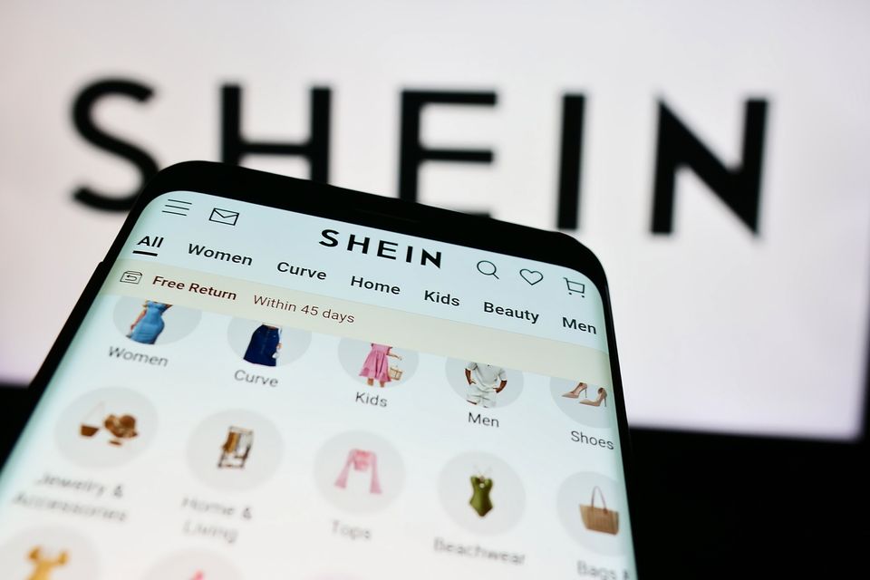 GERMANY - 2024/08/16: In this photo illustration, a smartphone with the website of fashion e-commerce company Shein is seen in front of business logo. (Photo Illustration by Timon Schneider/SOPA Images/LightRocket via Getty Images)