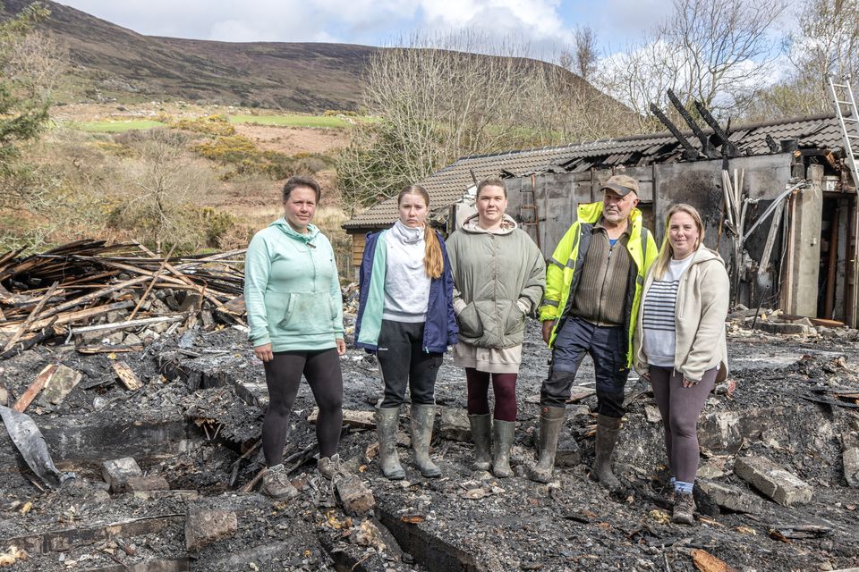 Pieter Bot with his daughters Wendy, Lonneke, and Linda and granddaughter Lily-Mae at the site of their family home which burnt to the ground on Good Friday. All that remains on the site are the partial walls of the workshop also on the site. The house is completely gone. Photo by Michael Donnelly.