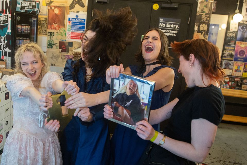 The Last Dinner Party pictured with their official number one award (Official Charts Company/PA)