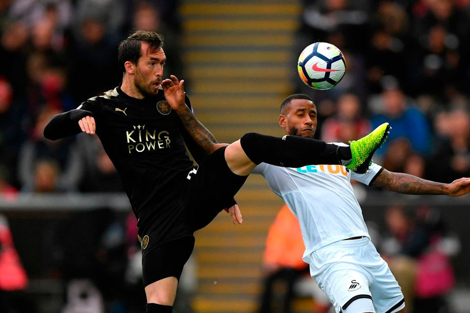 Leicester City's Christian Fuchs clashes with Swansea's Luciano Narsingh   Photo: Getty
