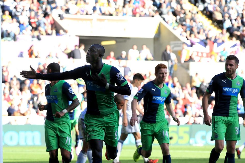 Newcastle striker Papiss Cisse, front, celebrates scoring his first goal in the 2-2 draw at Swansea.