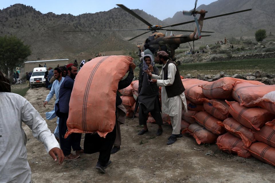 A man carries a sack in an area affected by an earthquake in Gayan, Afghanistan, June 23, 2022. Picture taken June 23, 2022. REUTERS/Ali Khara